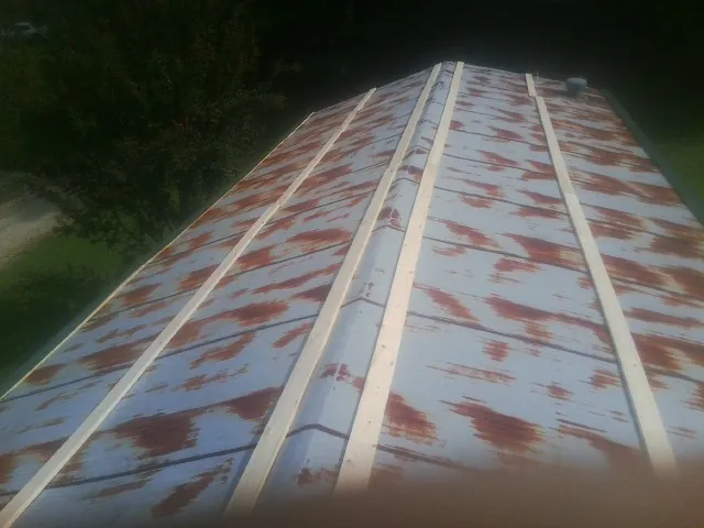 Rusted metal roof panels with new wood purlins before replacement — Storm Damage Roof Repair in Bailey Island by Roofing Brothers